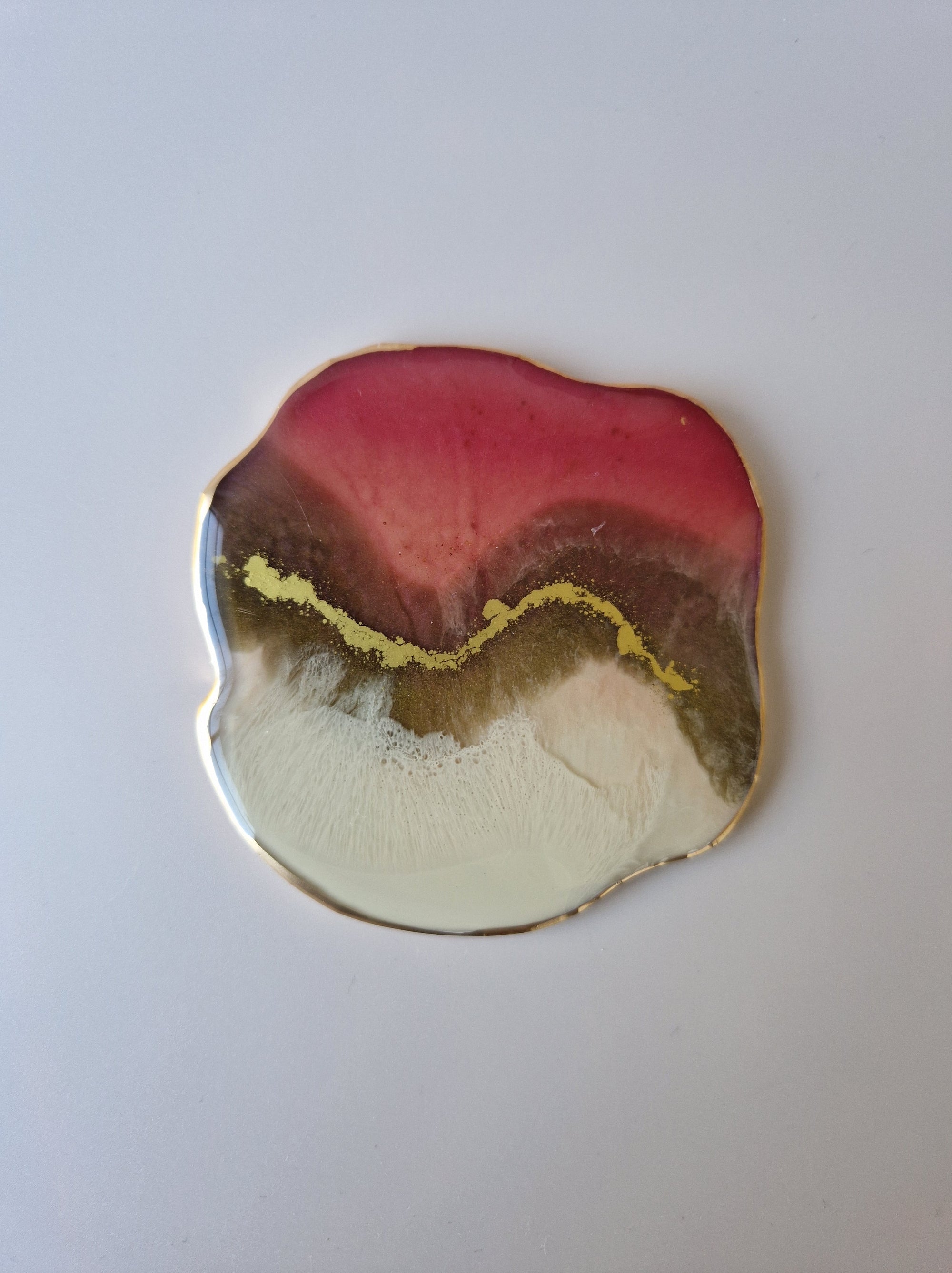 By Hand Onderzetter Tierra, handgemaakt van epoxy in roze, wit en bruin met goudaccent – luxe interieuraccessoire.