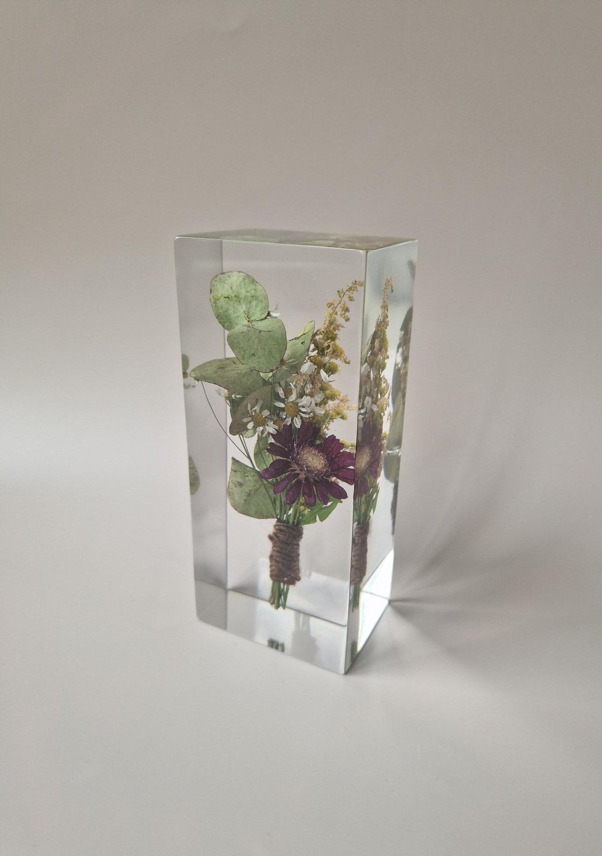 zijaanzicht
Bewaarde corsage van de bruidegom in epoxy, schuin gefotografeerd om de diepte van het aandenken te laten zien