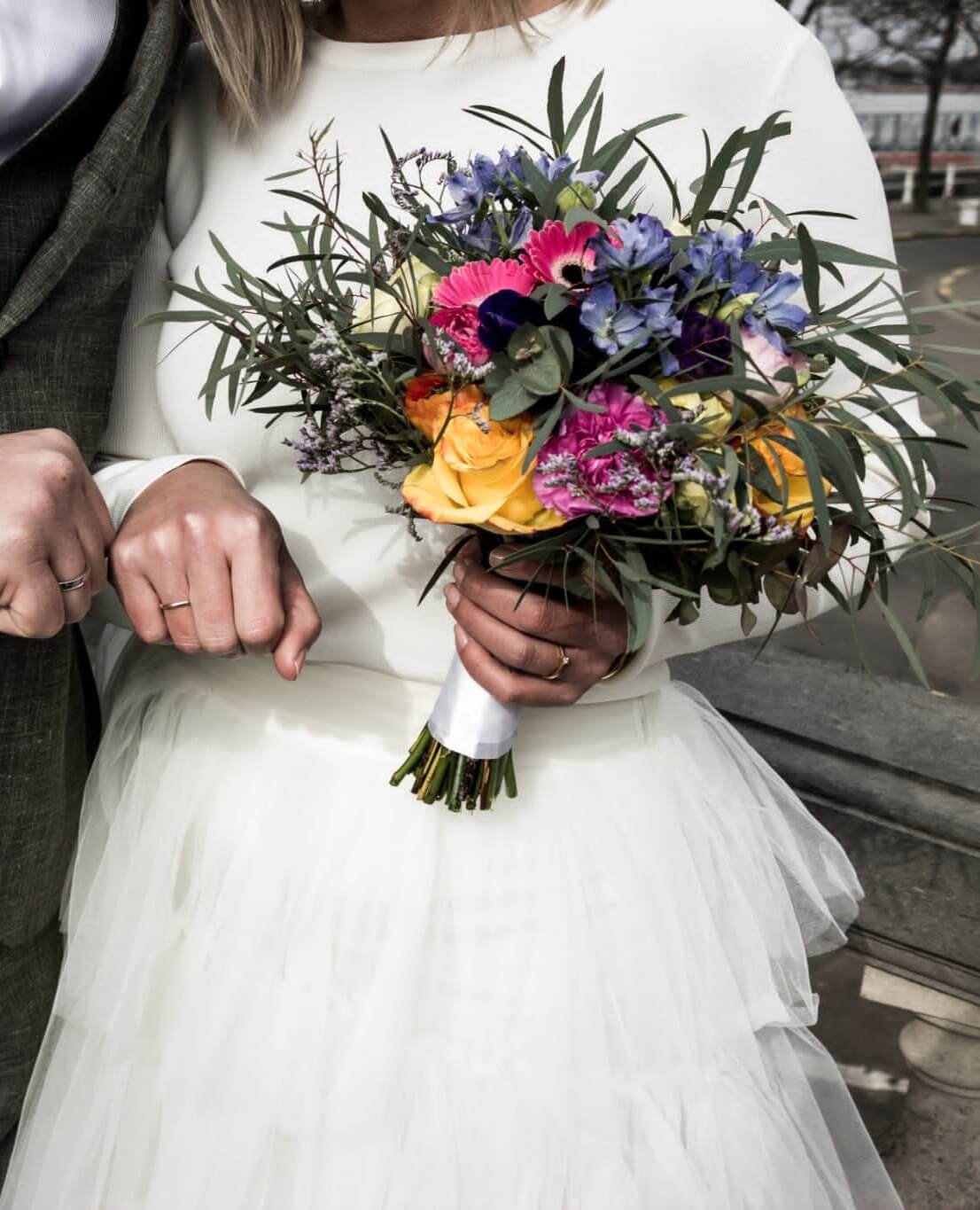 Bruid houdt haar bruidsboeket liefdevol vast, klaar om haar bloemen te laten bewaren in een Flower Shower van Moonstork.